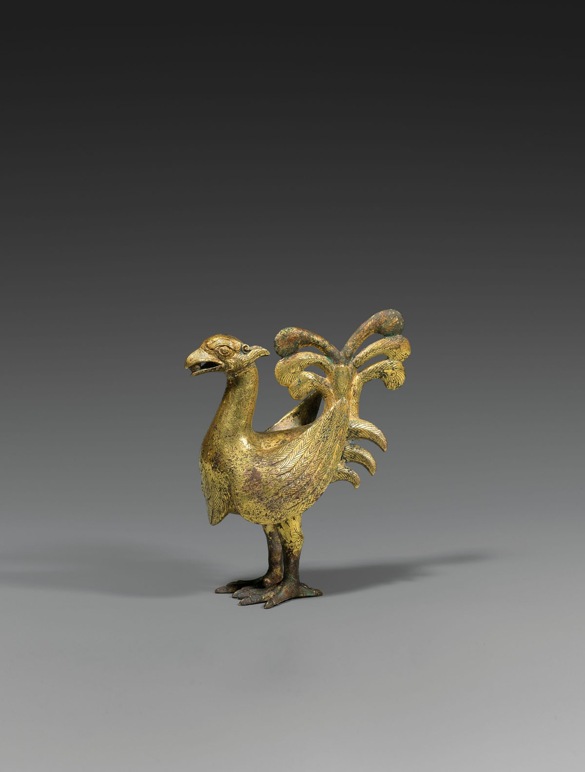 A gilt bronze figure of a phoenix, Western Han Dynasty (206 B.C. – A.D. 8). Height 4 11⁄16 inches (11.9 cm), in the exhibition Ancient Chinese Bronzes, J. J. Lally & Co., New York, 2011, cat. no. 20. © 2019 J.J. Lally & Co., New York