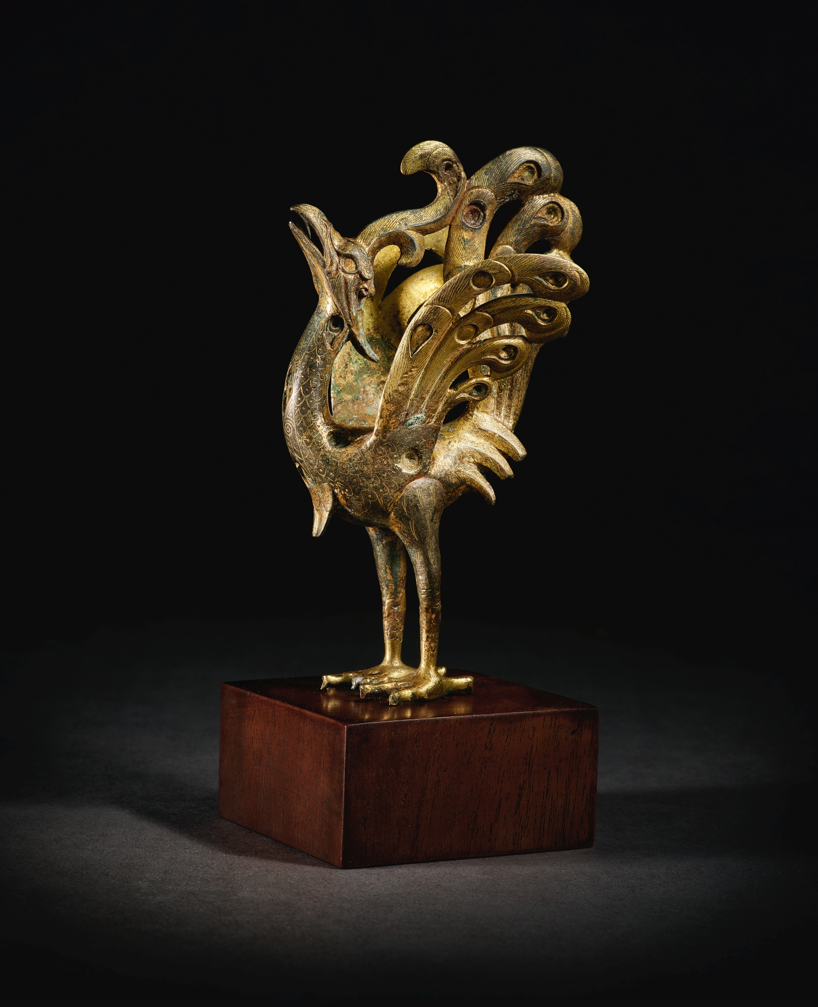 Lot 226. A splendid and rare gold and silver-inlaid parcel-gilt bronze figure of a peacock, Han dynasty (206 BC-AD 220). Height 6 1/8  in., 15.5 cm. Estimate 200,000 — 300,000 USD. Courtesy Sotheby's.