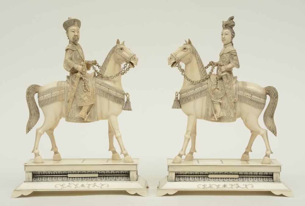 A pair of Chinese ivory figures of an imperial couple on horses,