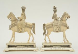 A pair of Chinese ivory figures of an imperial couple on horses,